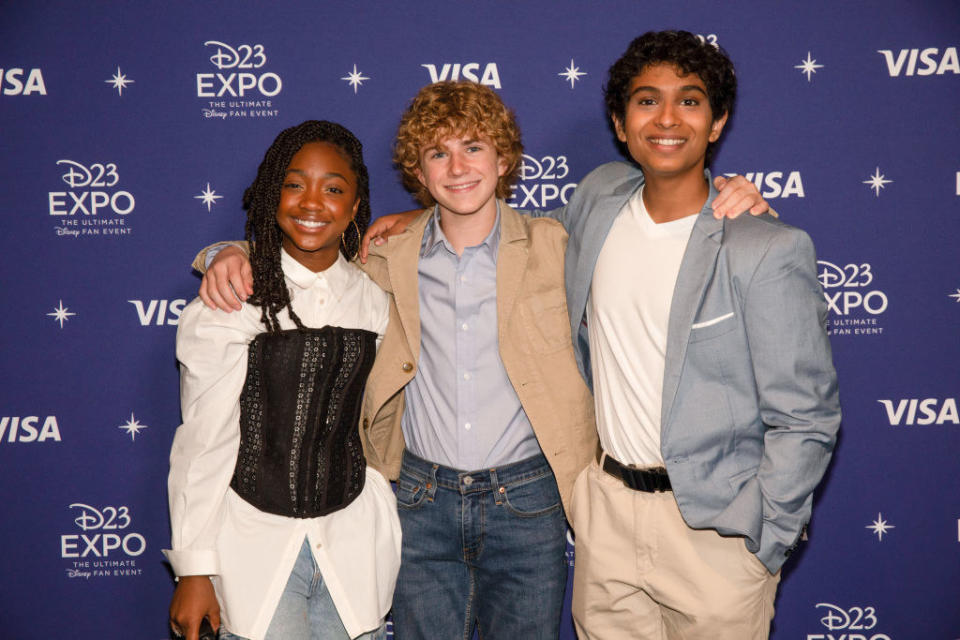 Three Percy Jackson actors hugging on the red carpet