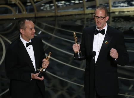 Pete Docter (R) and Jonas Rivera receive the Oscar for Best Animated Feature for "Inside Out" at the 88th Academy Awards in Hollywood, California February 28, 2016. REUTERS/Mario Anzuoni