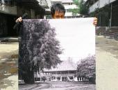 Before and after: A guide holds a photo depicting colonial Tanah Abang. The area now is full of shop houses.