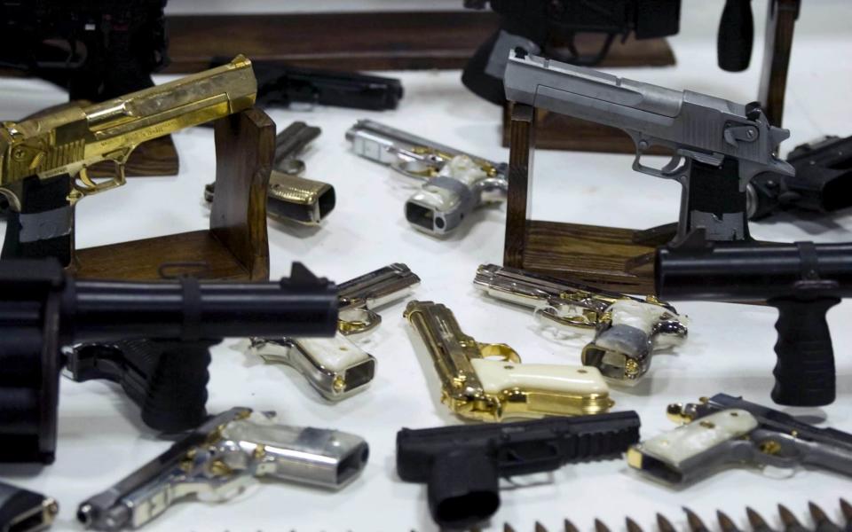 View of cartridgeds and weapons from the gangsters and drug-traffickers at the Military Headquarter in Mexico City - Credit: AFP