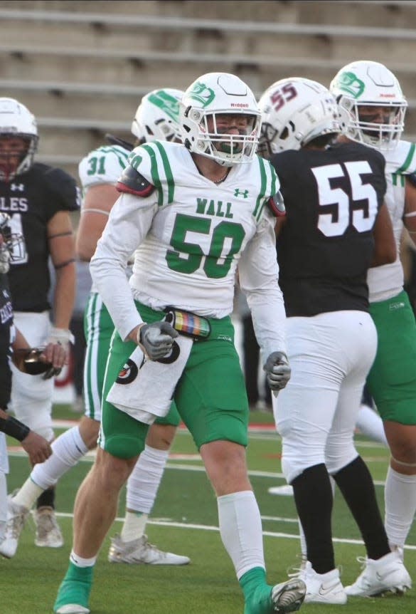 Wall football's Logan Thomas (50) celebrates after making a play.