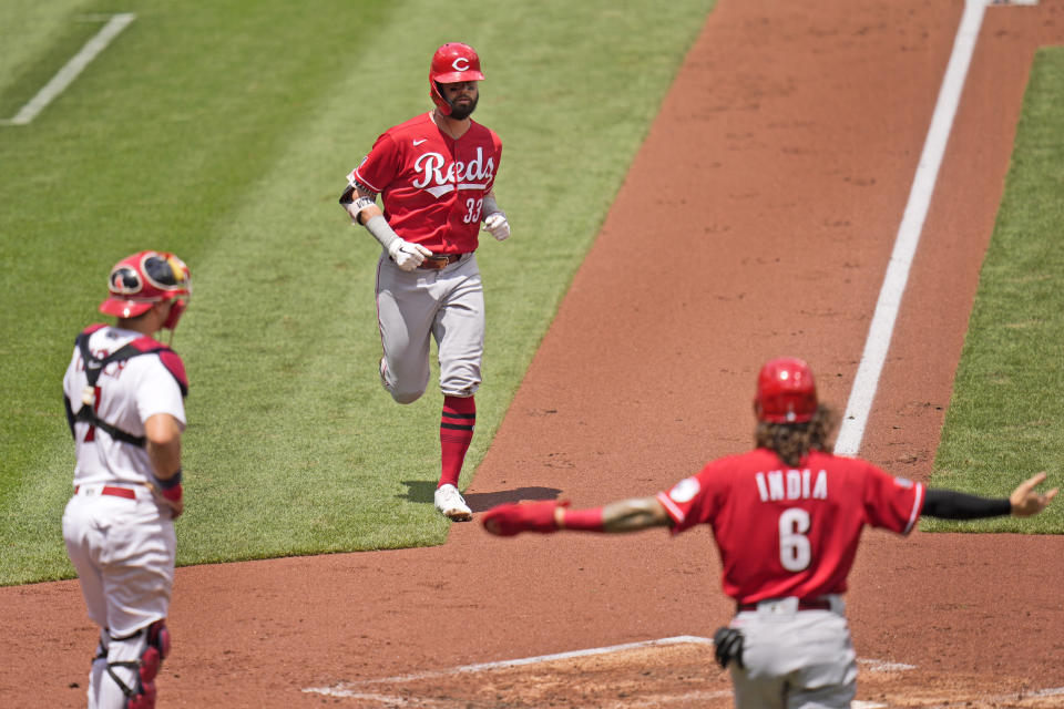 Cincinnati Reds' Jesse Winker (33) rounds the bases after hitting a two-run home run as teammate Jonathan India (6) and St. Louis Cardinals catcher Andrew Knizner, left, wait at home during the second inning of a baseball game Sunday, June 6, 2021, in St. Louis. (AP Photo/Jeff Roberson)