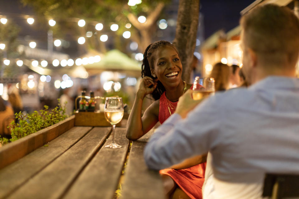 a lady and a man having a drink