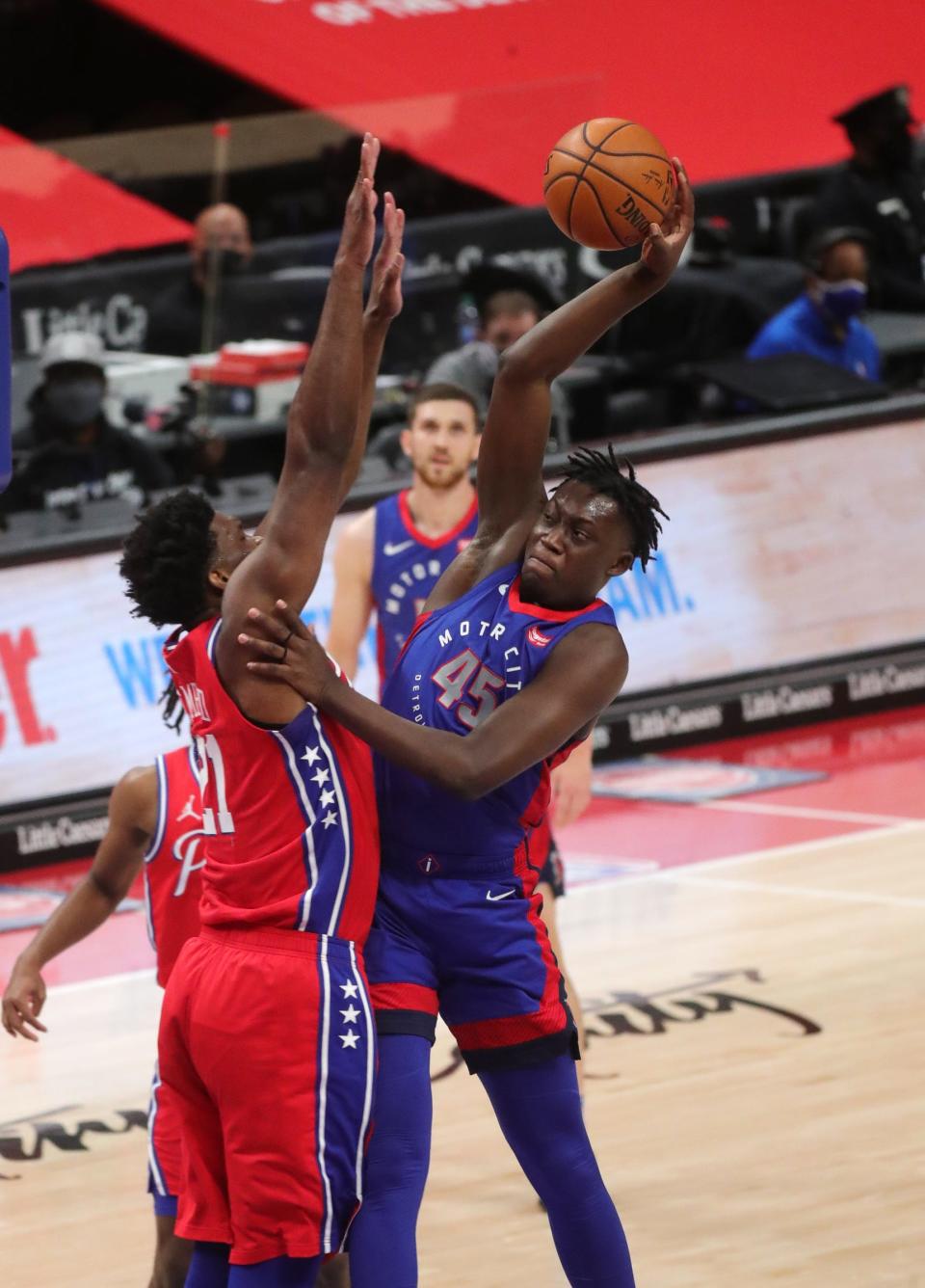 Detroit Pistons forward Sekou Doumbouya shoots against Philadelphia 76ers center Joel Embiid during the second quarter at Little Caesars Arena, Saturday, Jan.23, 2021.