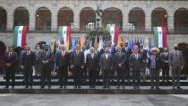 In this handout photo released by Mexico's Presidential Press Office, leaders from Latin America and the Caribbean pose for a group photo in a courtyard of the National Palace during the Community of Latin American and Caribbean States, or CELAC summit, in Mexico City, Saturday, Sept. 18, 2021. (Mexico's Presidential Press Office via AP)