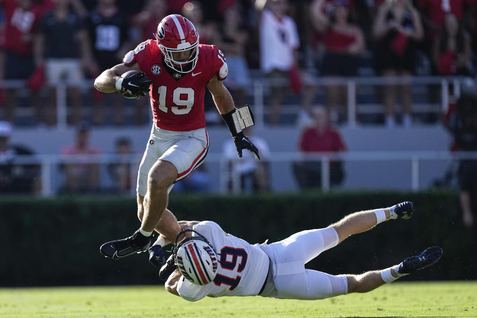 Georgia tight end Brock Bowers, top, gets past Tennessee-Martin safety Jack Lucas, bottom, after making a catch during the first half of an NCAA college football game Saturday, Sept. 2, 2023, in Athens, Ga. (AP Photo/John Bazemore)