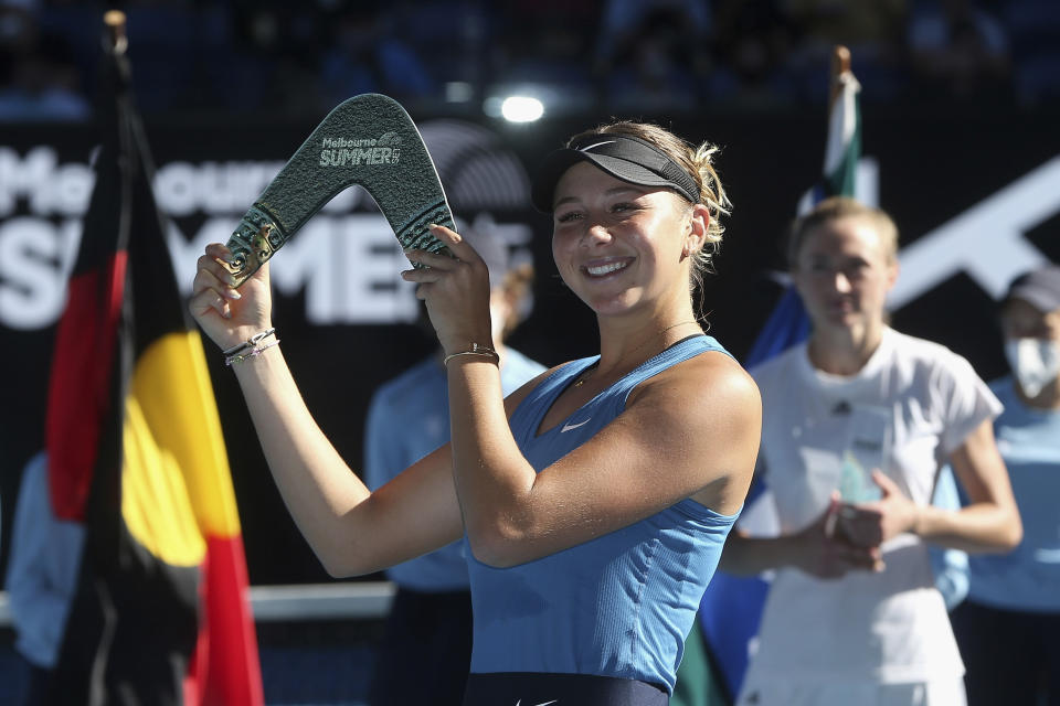 Amanda Anisimova of the United States holds the winner's trophy after her singles match against Aliaksandra Sasnovich of Belarus during the women's final of the Summer Set 2 tournament ahead of the Australian Open in Melbourne, Australia, Sunday, Jan. 9, 2022. (AP Photo/Hamish Blair)