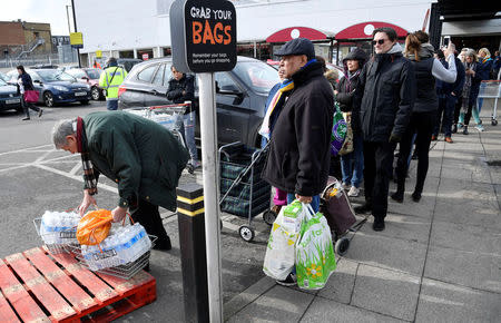 Local residents collect bottled water distributed by Thames Water after mains supplies to homes were cut off following bad weather, in Balham, south London, March 5, 2018. REUTERS/Toby Melville