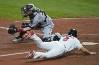 Cleveland Indians' Mike Freeman scores as Chicago White Sox catcher Yasmani Grandal waits for the throw during the seventh inning of a baseball game Thursday, Sept. 24, 2020, in Cleveland. The Indians won 5-4. (AP Photo/Tony Dejak)