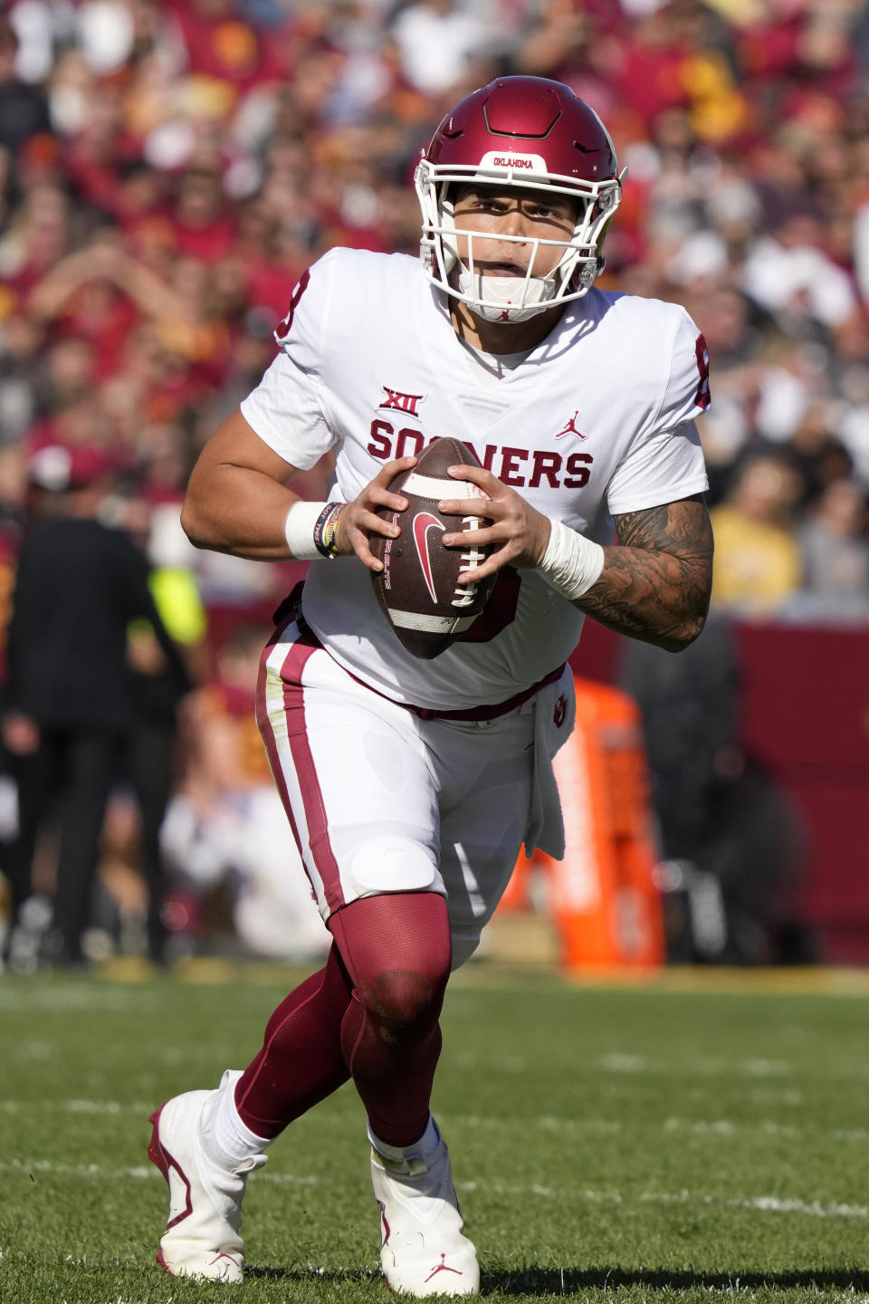 Oklahoma quarterback Dillon Gabriel (8) scrambles up field during the first half of an NCAA college football game against Iowa State, Saturday, Oct. 29, 2022, in Ames, Iowa. (AP Photo/Charlie Neibergall)