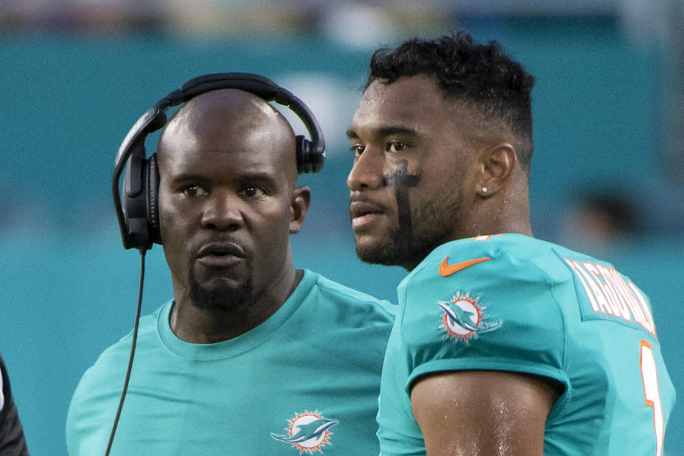 FILE - Miami Dolphins head coach Brian Flores, left, and quarterback Tua Tagovailoa (1) talk on the sidelines as the Atlanta Falcons take on the Miami Dolphins during a preseason NFL football game in Miami Gardens, Fla., i this Saturday, Aug. 21, 2021, file photo. (AP Photo/Doug Murray, File)