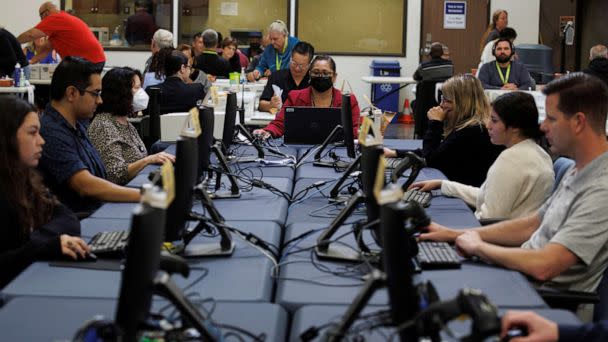 PHOTO: Election workers verify ballot signatures at the Orange County Registrar of Voters during a media tour showing ballot security for the November 8, 2022 election, in Santa Ana, Calif., November 1, 2022. (Mike Blake/Reuters)