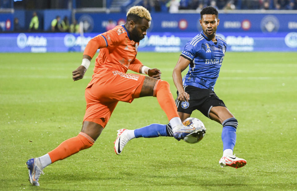 CF Montreal's Ariel Lassiter, right, defends against FC Cincinnati's Aaron Boupendza during the first half of an MLS soccer match Wednesday, Sept. 20, 2023, in Montreal. (Graham Hughes/The Canadian Press via AP)