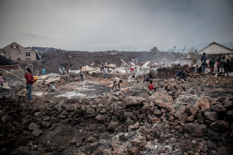 <p>Vecinos de la ciudad separan las rocas de lava que se han enfriado días después de la erupción. (Foto: Guerchom Ndebo / AFP / Getty Images).</p> 