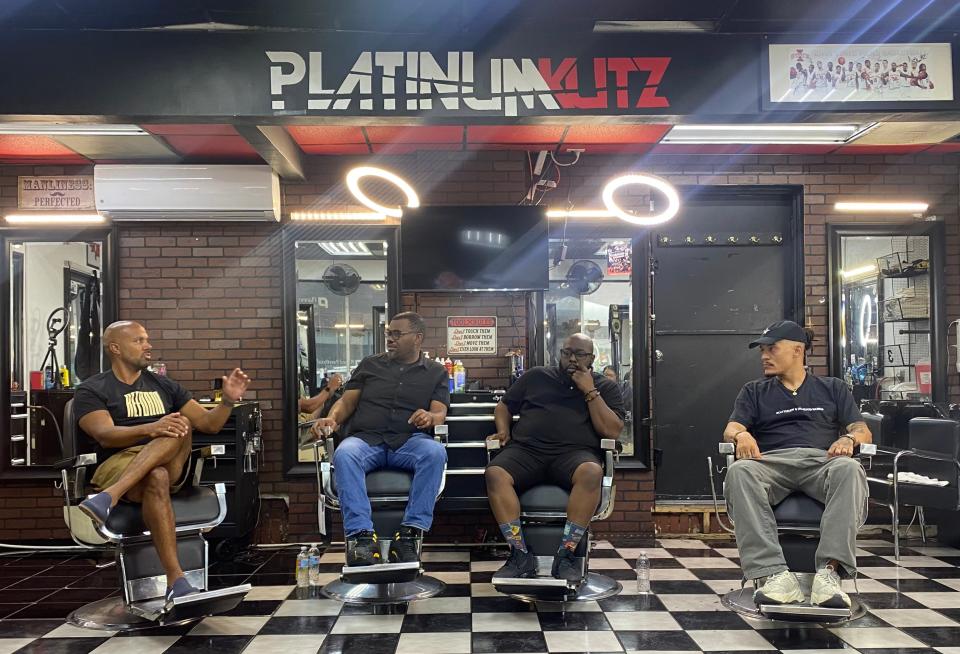 Reform Alliance CEO Robert Rooks (second from left) leads a panel event at Platinum Kutz with state Sen. Izaah Knox, pastor and community activist Rob Johnson and renowned artist Robert Moore.