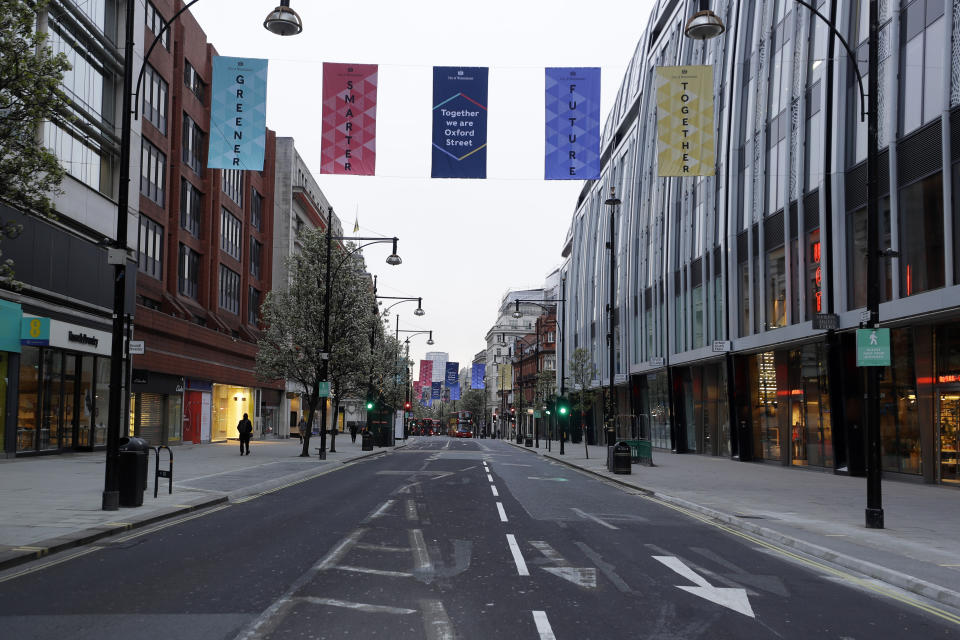 FILE - In this Monday, April 12, 2021 file photo, empty Oxford Street in London before shops open at 7:00am, after coronavirus measures were lifted. The British economy contracted by 1.5% in the first quarter of 2021, a relatively modest contraction given that the country was in the midst of a strict lockdown to combat a second wave of the coronavirus. The Office for National Statistics also said Wednesday May 12, 2021, that the economy even managed to grow by 2.1% in March when the country began easing some restrictions. (AP Photo/Kirsty Wigglesworth, File)