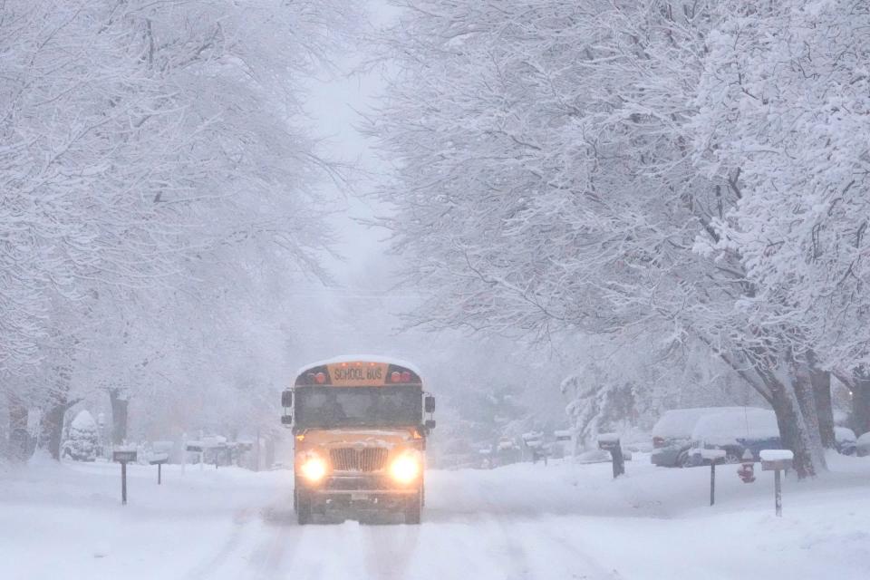 A school bus heads through the snow down North Seneca Road in Glendale on Thursday. Overnight snow blanketed the Milwaukee area, and another system is expected to arrive Friday bringing both snow and eventually below-zero temperatures.
