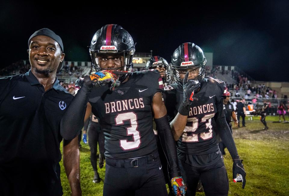 Palm Beach Central players Tony Williams, (3) and Cameron Dwyer, (23) celebrate their 27-24 win over Benjamin in Wellington, Florida on October 6, 2023.