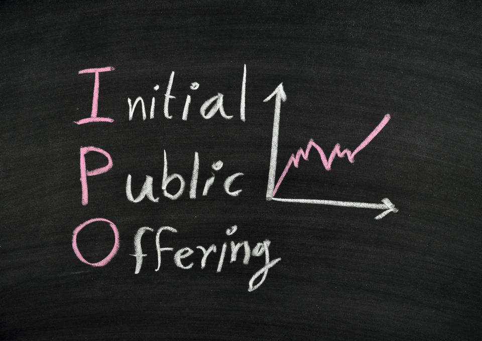 The words "initial public offering" written on a chalkboard.