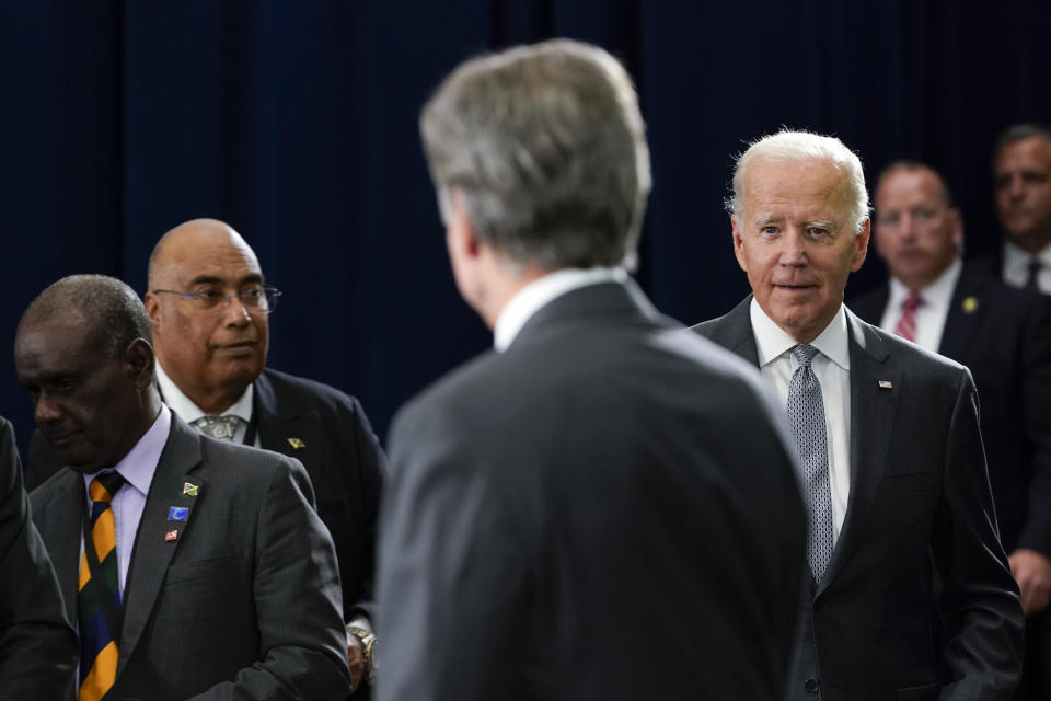 President Joe Biden arrives to speak after being introduced by Secretary of State Antony Blinken, center, during the first U.S.-Pacific Island Country Summit at the State Department in Washington, Thursday, Sept. 29, 2022. (AP Photo/Susan Walsh)