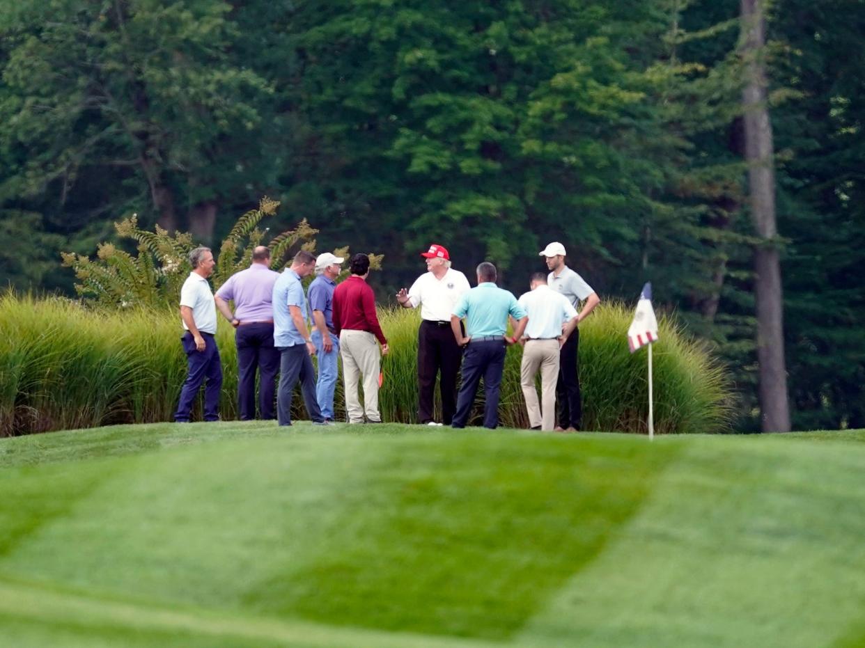 Donald Trump and a group of men standing on his golf course in Northern Virginia.