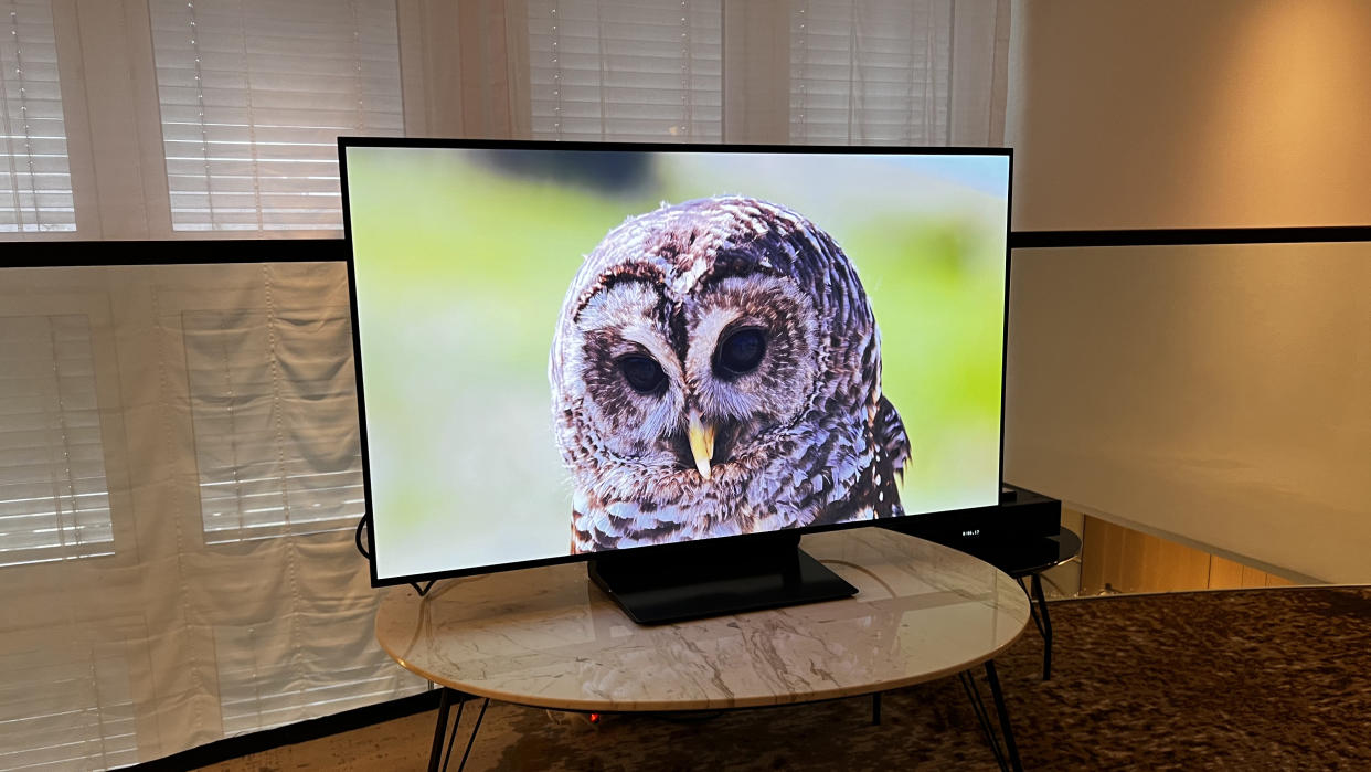  Samsung S90D 48-inch OLED TV on a wooden table. 