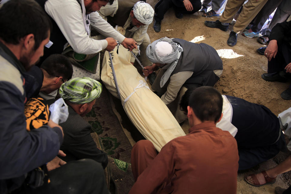 Afghan men bury a victim of bombings on Saturday near a school, west of Kabul, Afghanistan, Sunday, May 9, 2021. The Interior Ministry said the death toll in the horrific bombing at the entrance to a girls' school in the Afghan capital has soared to some 50 people, many of them pupils between 11 and 15 years old, and the number of wounded in Saturday’s attack has also climbed to more than 100. (AP Photo/Mariam Zuhaib)