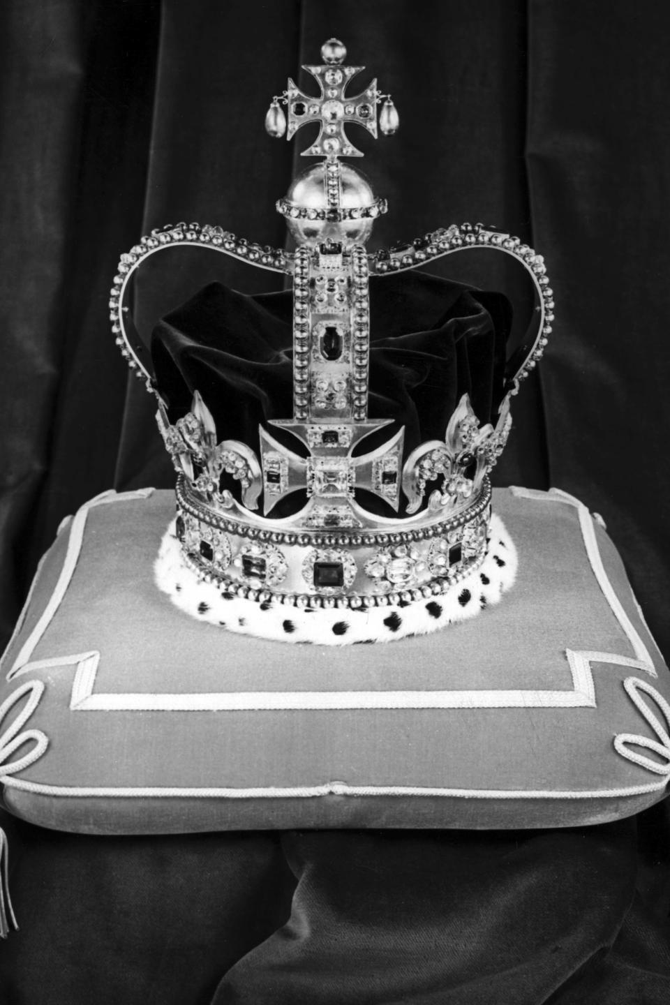 FILE - St. Edward's Crown, the official Crown of England, sits on a cushion, at the Tower of London, on Nov. 24, 1952 before being used at Queen Elizabeth II's Coronation Ceremony, on June 5, 1953. The crowning moment of King Charles III's coronation ceremony will occur, literally, when the Archbishop of Canterbury places St. Edward’s Crown on King Charles’ head. Because of its significance as the centerpiece of the coronation, this will be the only time during his reign that the monarch will wear the solid gold crown, which features a purple velvet cap, ermine band and criss-crossed arches topped by a cross. (AP Photo, File)