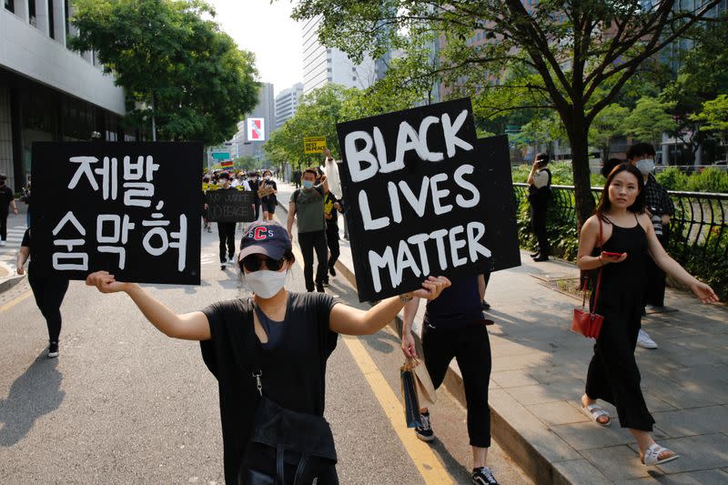 People march on the street in solidarity with protests against the death in Minneapolis police custody of George Floyd in Seoul