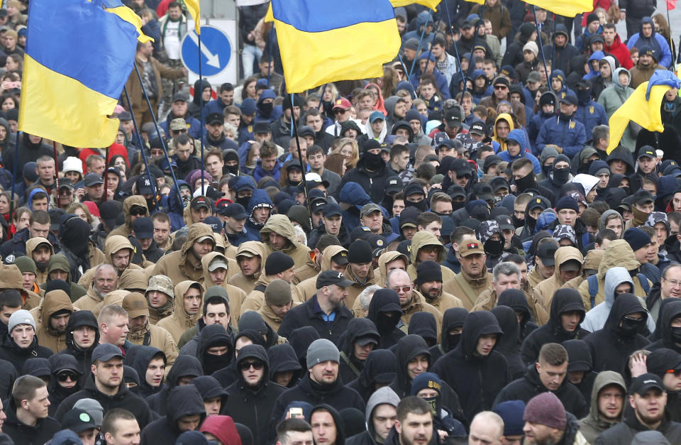 Holding Ukrainian state flags, members of far-right groups hold a mass demonstration against government corruption on the Independence Square in Kiev, Ukraine, Saturday, March 23, 2019.(AP Photo/Efrem Lukatsky)