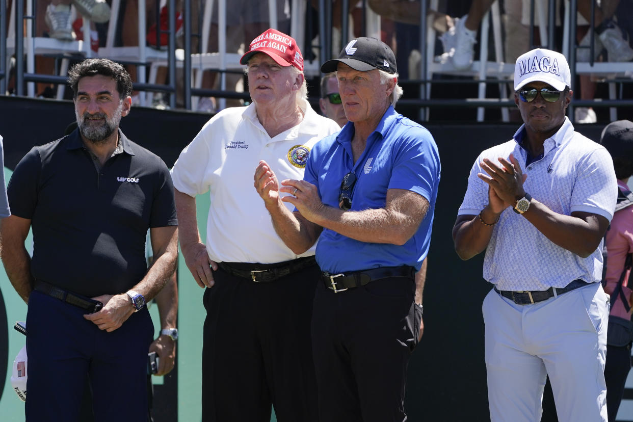 FILE - Yasir Al-Rumayyan, governor of Saudi Arabia's Public Investment Fund, left, former President Donald Trump, second from left, Greg Norman, LIV Golf CEO, third from left, and Majed Al-Sorour, CEO of Golf Saudi, watch the start of the second round of the Bedminster Invitational LIV Golf tournament in Bedminster, N.J., July 30, 2022. (AP Photo/Seth Wenig, File)