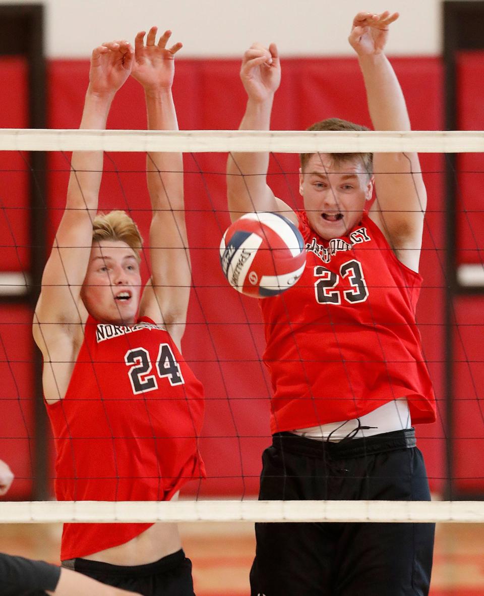 North Quincy's Cameron Johnston and Dylan Clifford try to block a Nipmuc volley.