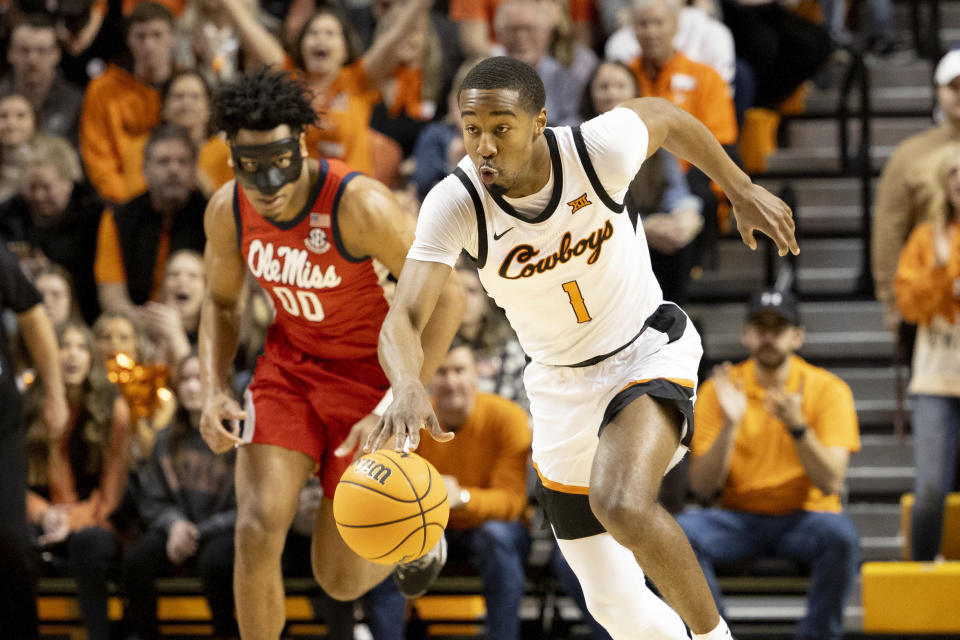Oklahoma State's Bryce Thompson (1) drives the ball upcourt past Mississippi's Jayveous McKinnis (00) during the first half of an NCAA college basketball game in Stillwater, Okla., Saturday, Jan. 28, 2023. (AP Photo/Mitch Alcala)