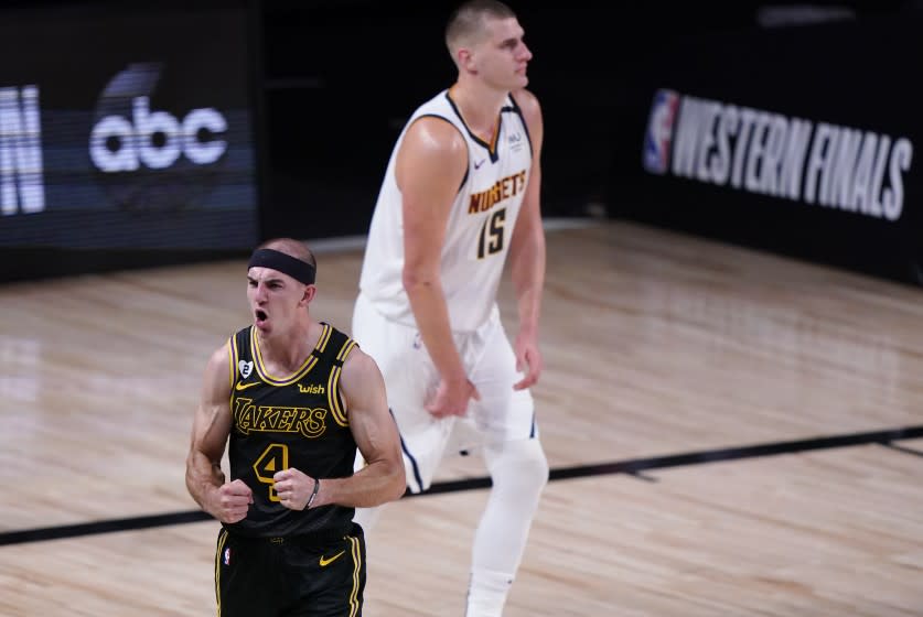 Los Angeles Lakers' Alex Caruso (4) celebrates in front of Denver Nuggets' Nikola Jokic.