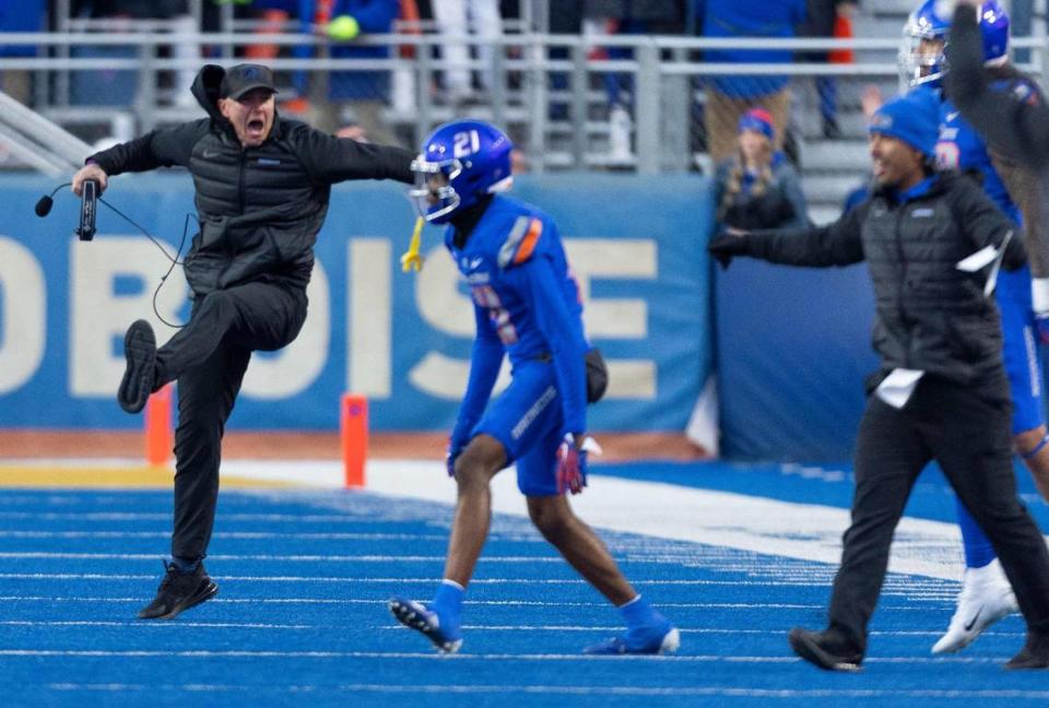 Boise State interim head coach Spencer Danielson, far left, celebrates the 27-19 win over Air Force with other Broncos.