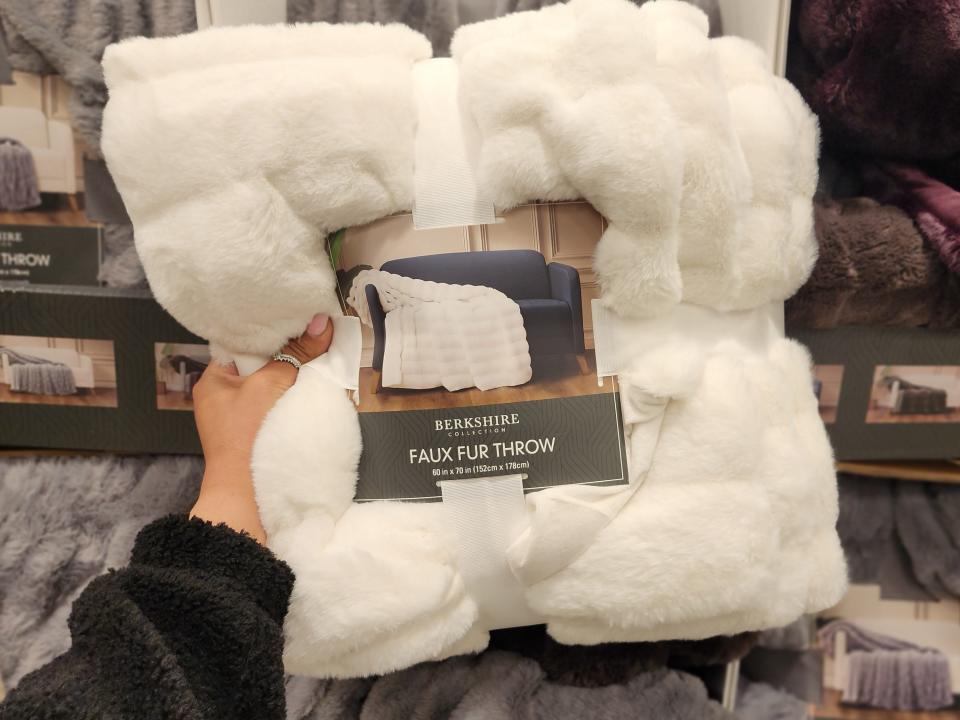 A white faux-fur throw.