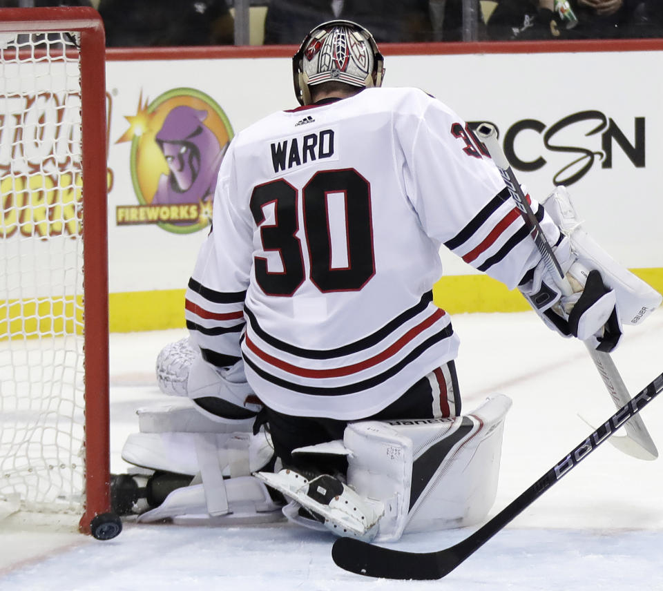 A shot by Pittsburgh Penguins' Derick Brassard gets between the pads of Chicago Blackhawks goaltender Cam Ward (30) for a goal in the second period of an NHL hockey game in Pittsburgh, Sunday, Jan. 6, 2019. (AP Photo/Gene J. Puskar)