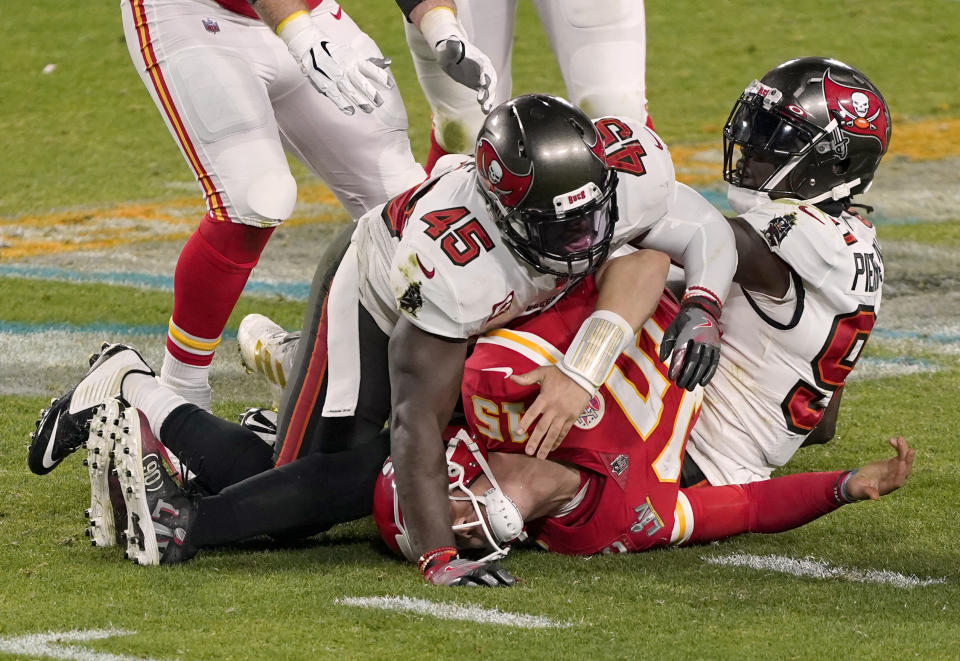 FILE - Kansas City Chiefs quarterback Patrick Mahomes (15) is sacked by Tampa Bay Buccaneers inside linebacker Devin White (45) and outside linebacker Jason Pierre-Paul (90) during the second half of NFL Super Bowl 55 football game against the Kansas City Chiefs in Tampa, Fla., in this Sunday, Feb. 7, 2021, file photo The Kansas City Chiefs already have spent the offseason rebuilding an offensive line ravaged by injuries and then dominated by Tampa Bay in the Super Bowl. But there is still work to be done, and the next opportunity to provide some help up front for quarterback Patrick Mahomes is the NFL draft. (AP Photo/Jason Behnken, File)