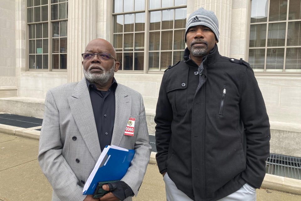 FILE - Willie Earvin Jr., left and Larry Pippion stand after testifying at the sentencing of Alex Banta, a former state correctional officer, at U.S. District Court on Thursday, March 16, 2023, in Springfield, Ill. Banta, 31, was sentenced to 20 years in federal prison for his role in the May 2018 beating death of Larry Earvin, 65, Willie Earvin's brother and Pippion's father. One of Banta's co-defendants, Willie Hedden, the last of three ex-correctional officers convicted in the beating death of the Illinois prison inmate, was sentenced Wednesday, March 22, to six years in federal prison after pleading guilty to civil rights violations and obstruction and testifying against his codefendants. (AP Photo/John O'Connor, File)