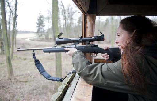With a chill wind whistling through the raised hide set among the trees and undergrowth, Johanna Hofmann sweeps her hair back from her face as she watches and listens, her rifle to hand