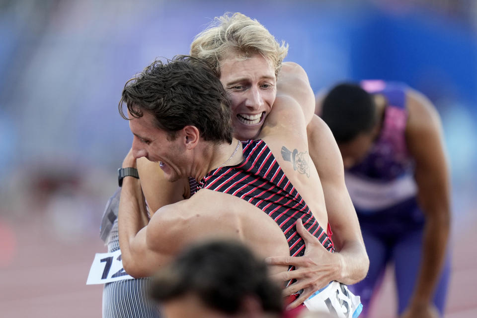 Canada's Robert Joseph Heppenstall, front, embraces teammate Charles Philibert-Thiboutot after they took second and first, respectively, in the men's 1,500 meters at the Pan American Games in Santiago, Chile, Thursday, Nov. 2, 2023. (rank Gunn/The Canadian Press via AP)