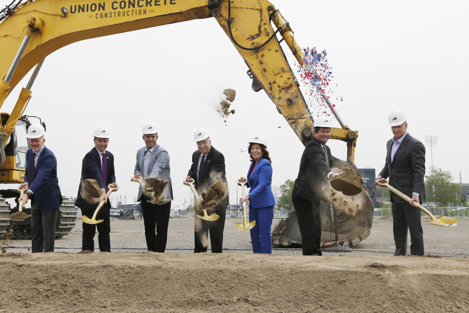 FILE - From left, Buffalo Bills head coach Sean McDermott, General Manager Brandon Beane, EVP/Chief Operating Officer Ron Raccuia, owner Terry Pegula, New York Governor Kathy Hochul, Erie County Executive Mark Poloncarz and NFL commissioner Roger Goodell participate in the groundbreaking ceremony at the site of the new Bills Stadium in Orchard Park, N.Y., Monday June 5, 2023. Proposals for new and improved sports stadiums are proliferating across the U.S. — and could come with a hefty price tag for taxpayers. This past year alone, roughly a dozen Major League Baseball and National Football League franchises took steps toward building new stadiums or making major renovations to their current ones. (AP Photo/Jeffrey T. Barnes, File)