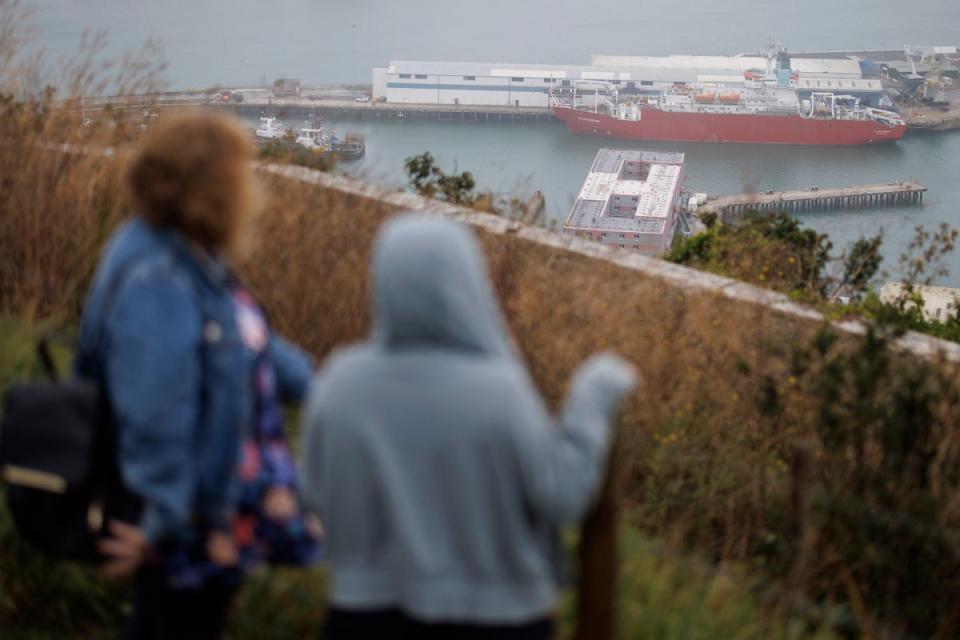 People look on at the Bibby Stockholm barge docked in Portland Port (EPA)