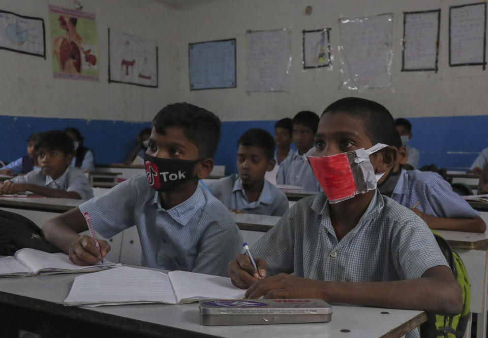 Indian student attend a class wearing face masks to protect themselves from coronavirus in Hyderabad.