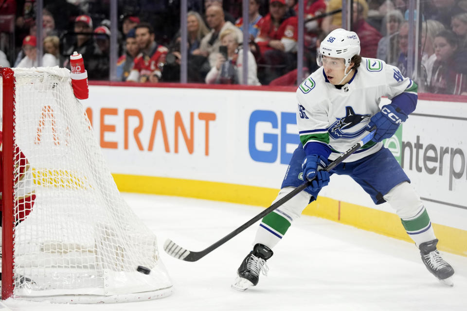 Vancouver Canucks left wing Andrei Kuzmenko passes the puck during the first period of an NHL hockey game against the Florida Panthers, Saturday, Jan. 14, 2023, in Sunrise, Fla. (AP Photo/Wilfredo Lee)