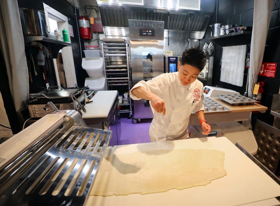 Chef Tae Tran sprinkles flour while laminating dough at Ma Façon TR in Poulsbo.