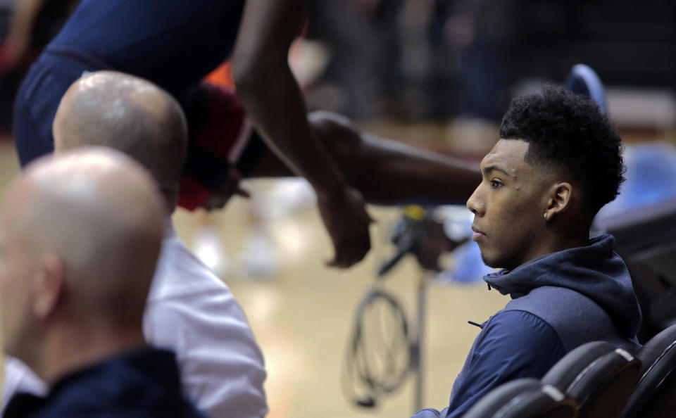 Arizona guard Allonzo Trier, right, sits courtside as teammates warm up before facing Oregon State last Thursday (AP)