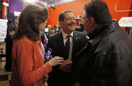 Chicago Mayoral candidate Jesus "Chuy" Garcia (C) laughs with supporters at a rally in Chicago, Illinois, January 15, 2015. REUTERS/Jim Young