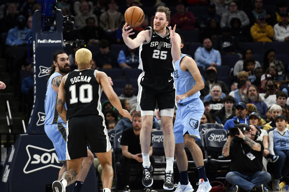 San Antonio Spurs center Jakob Poeltl (25) grabs the ball in the first half of an NBA basketball game against the Memphis Grizzlies, Monday, Jan. 9, 2023, in Memphis, Tenn. (AP Photo/Brandon Dill)