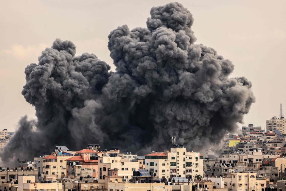 A plume of smoke rises in the sky of Gaza City during an Israeli airstrike on the third day since Hamas launched its attack on Israel (AFP via Getty Images)